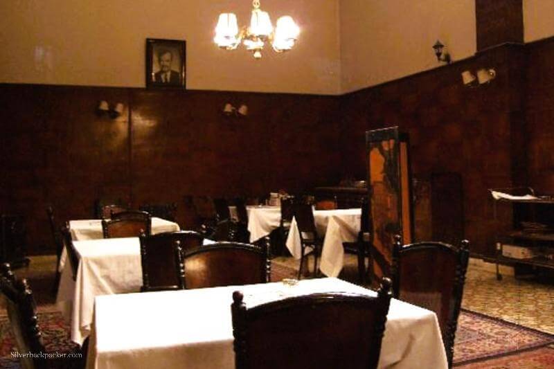 dining room with photo of President Assad on the wall