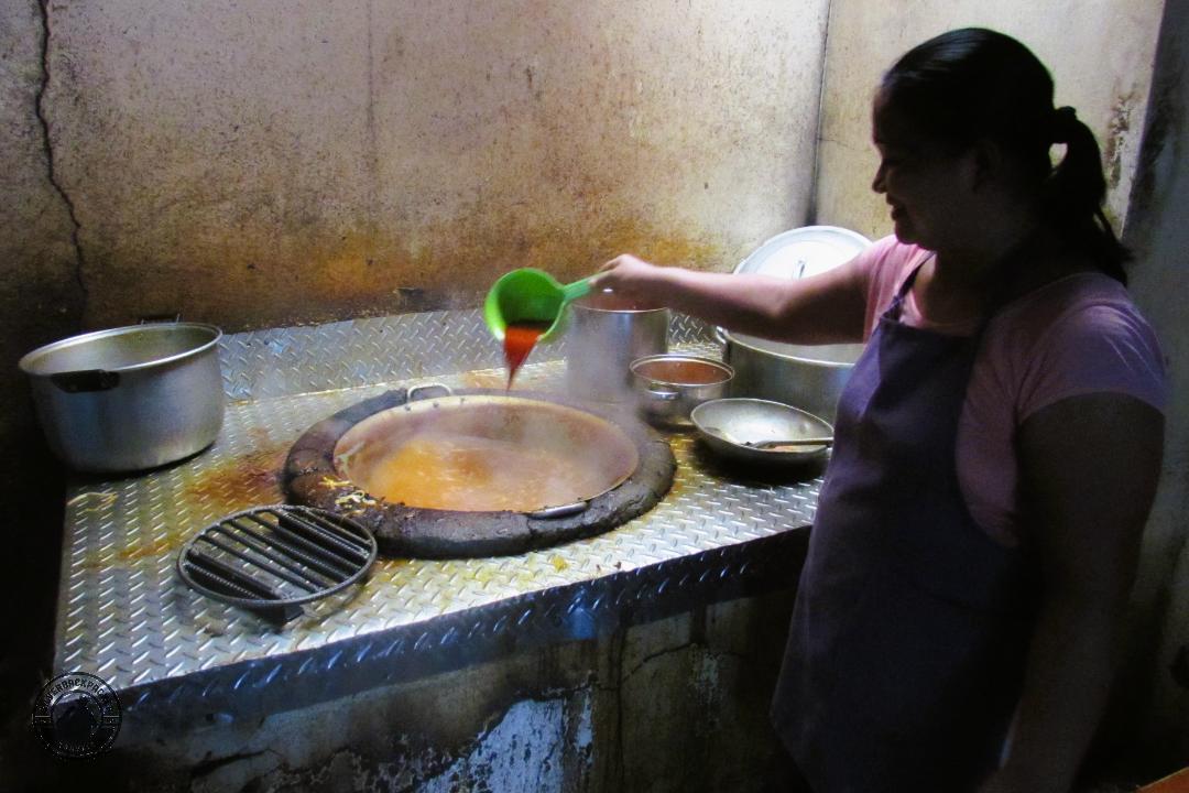 big pot of broth boiling on a wood fire