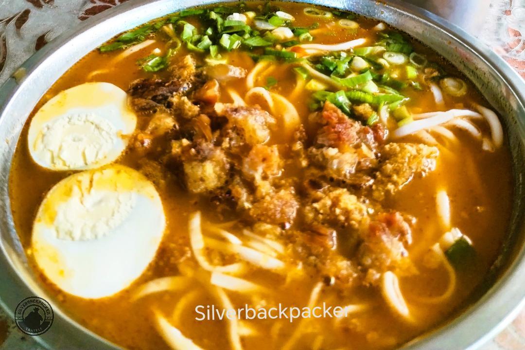 bowl of abra miki with two eggs, noodles and meat