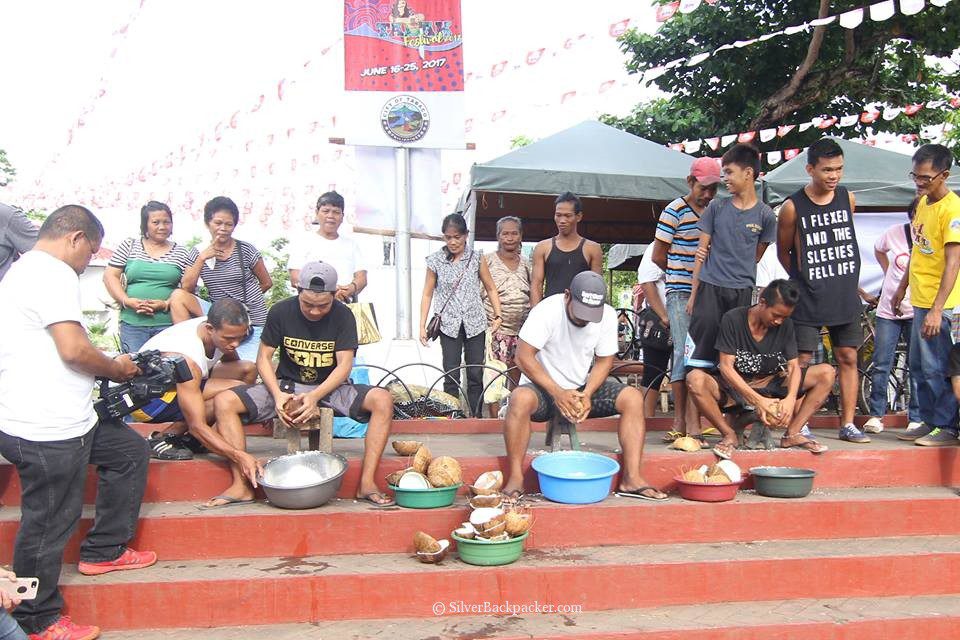 Using a kudkudan to grate the coconut meat. tabak festival